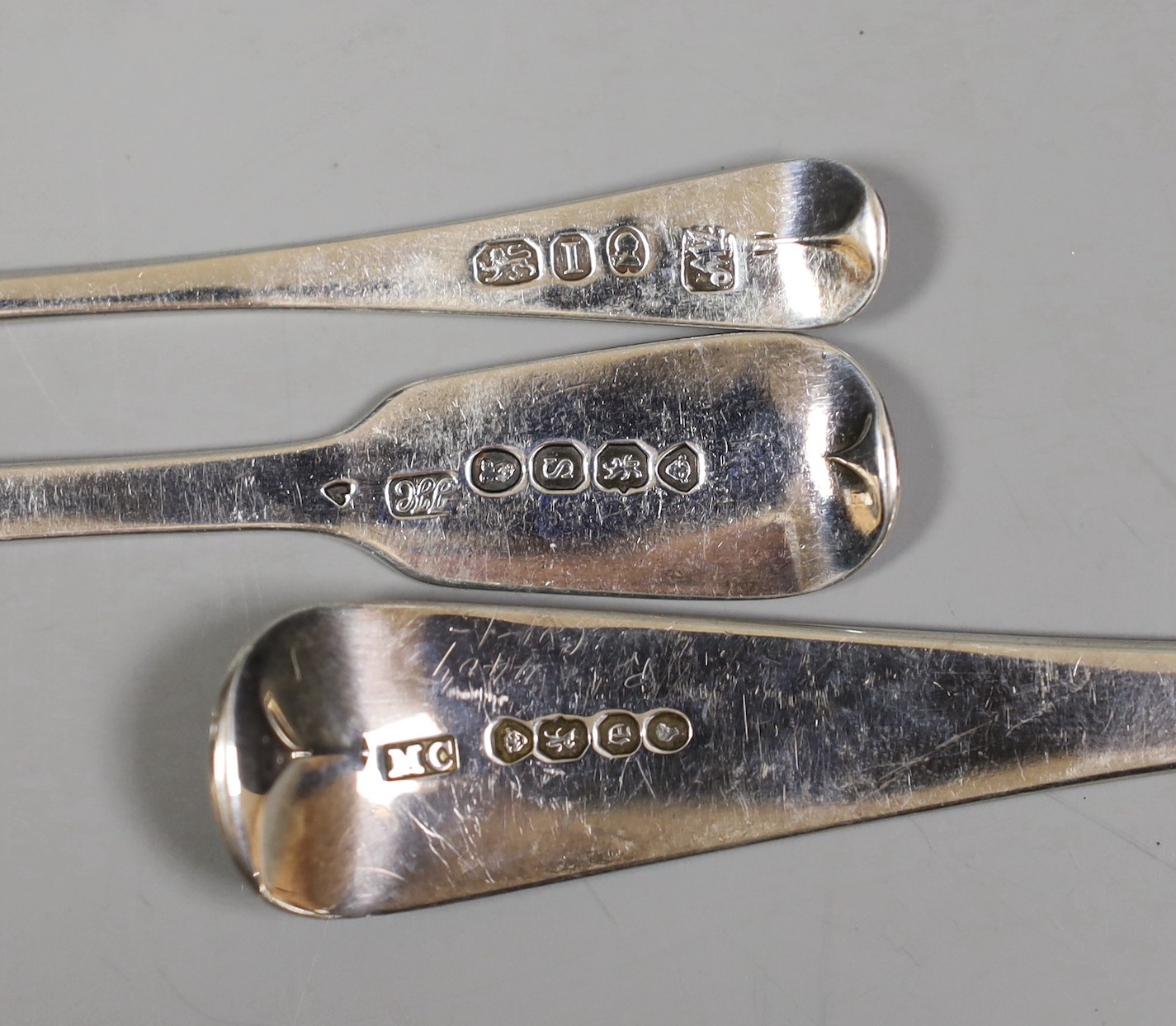 A composite set of six George III Old English pattern and fiddle pattern spoons for condiments, a William IV silver caddy spoons and a Victorian silver sauce ladle, 5.2oz